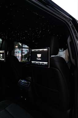 Luxury car interior with rear screens and starlit ceiling
