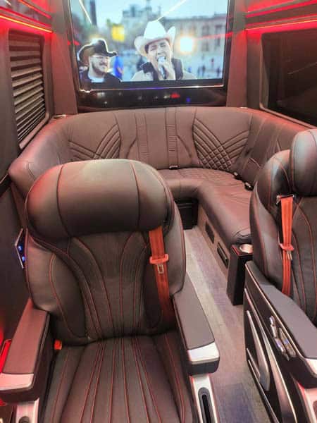 Luxury van interior with leather seats and TV