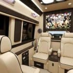 Luxury van interior with leather seats and TV