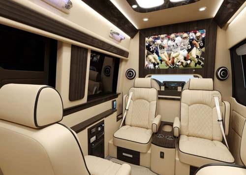Luxury van interior with leather seats and TV