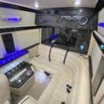 Luxury van interior with leather seats and blue lighting