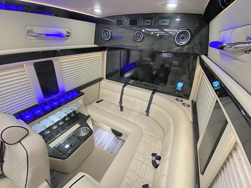 Luxury van interior with leather seats and blue lighting