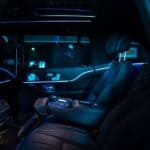 Luxury car interior with blue ambient lighting at night