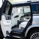 Open rear door of luxury SUV interior