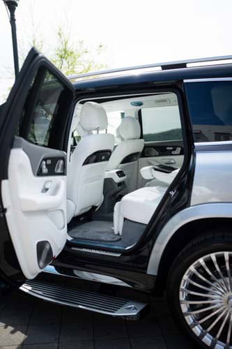 Open rear door of luxury SUV interior