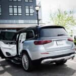 Silver SUV parked outside building with rear door open
