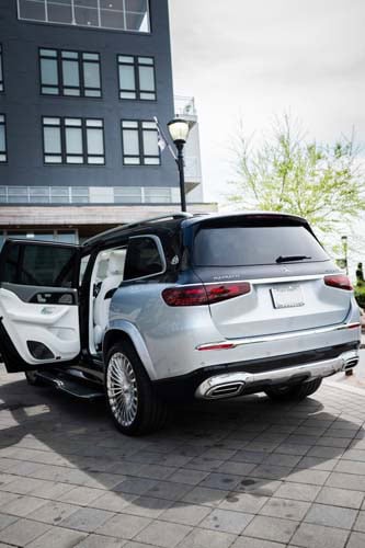 Silver SUV parked outside building with rear door open