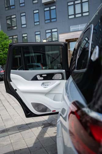 Open rear car door in urban parking area