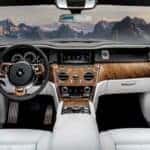 Luxury car interior with wood trim and mountain view