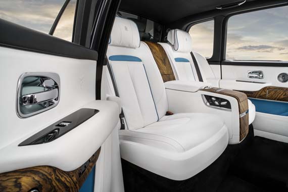 Luxury car rear interior with white leather seats