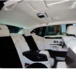 Luxury car rear seats with white leather interior