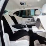 Luxury car interior with white leather rear seats