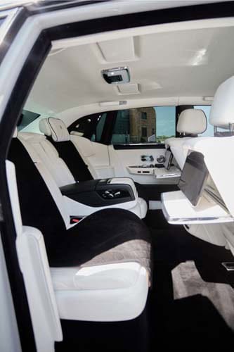 Luxury car interior with white leather rear seats