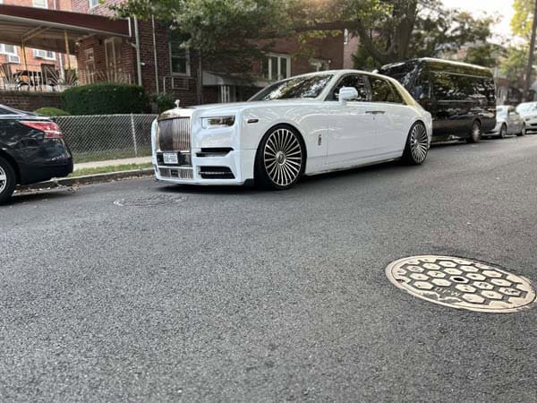 White Rolls-Royce sedan parked on residential street