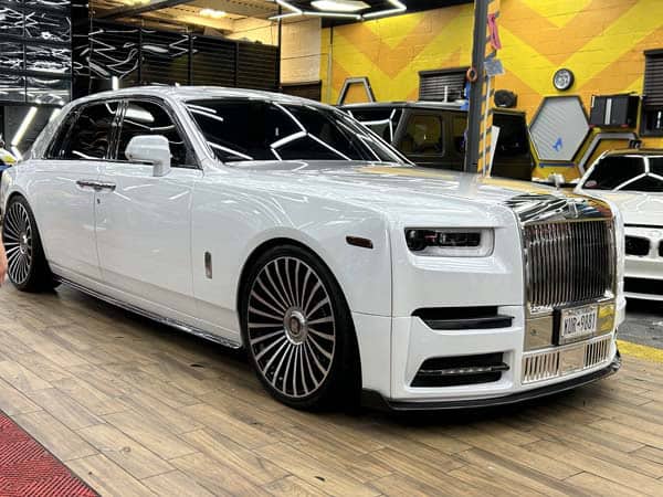 White Rolls-Royce sedan inside auto workshop
