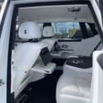 Luxury car interior with white leather rear seats