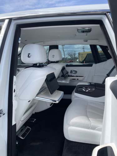 Luxury car interior with white leather rear seats