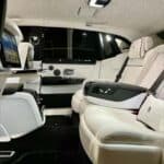 Luxury car rear cabin with white leather seats