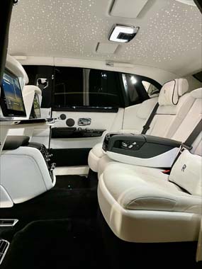 Luxury car rear cabin with white leather seats