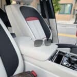 Luxury car interior with sunglasses on armrest