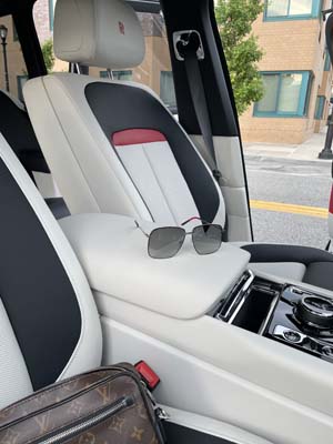 Luxury car interior with sunglasses on armrest