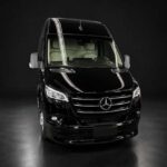 Sleek black Mercedes-Benz Sprinter van on dark background.