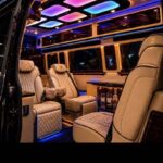 Luxury van interior with beige leather seats and LED lighting.