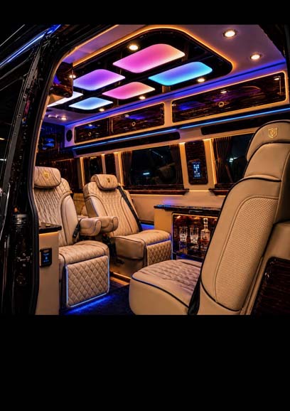 Luxury van interior with beige leather seats and LED lighting.