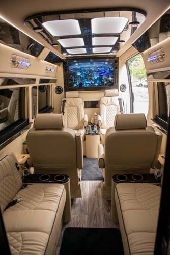 Luxury van interior with leather seats and large screen