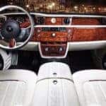 Luxury car interior with wood trim and white leather