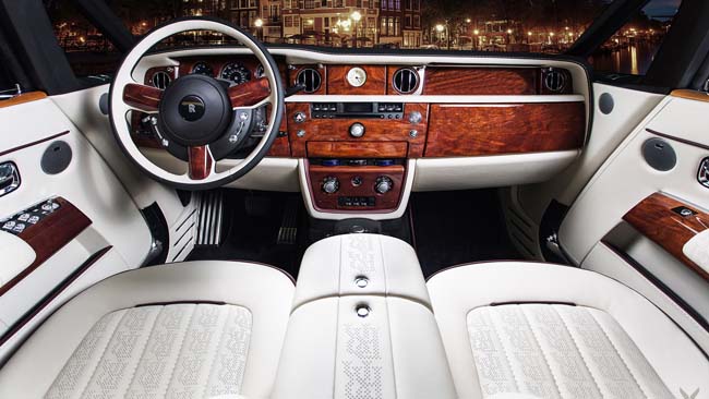 Luxury car interior with wood trim and white leather