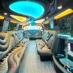Luxury party bus interior with neon lighting and leather seats