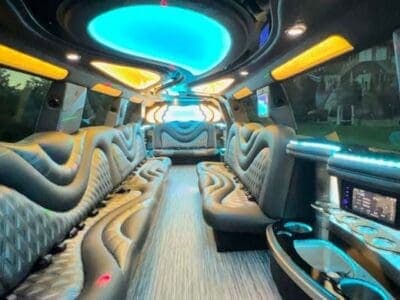 Luxury party bus interior with neon lighting and leather seats