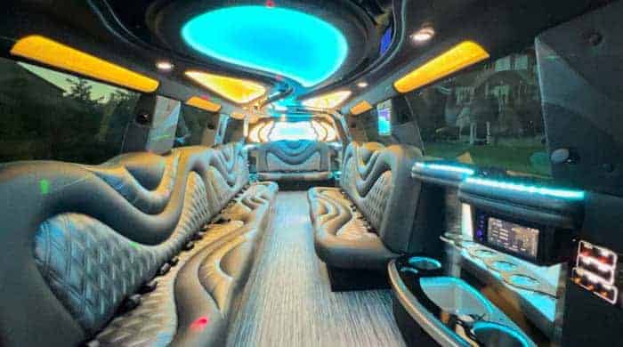 Luxury party bus interior with neon lighting and leather seats