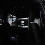 Luxury car interior with starlit headliner and screen