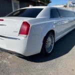 White Chrysler 300 stretch limousine parked outdoors