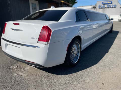 White Chrysler 300 stretch limousine parked outdoors