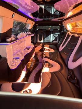 Luxury limousine interior with neon lighting and bar