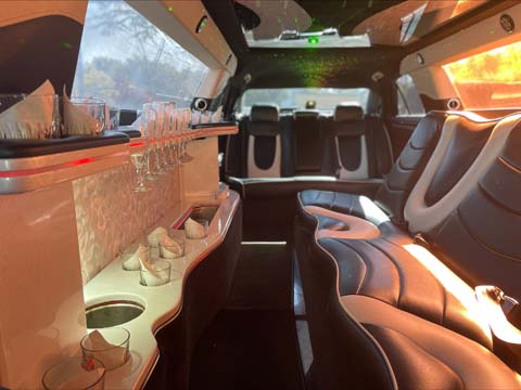 Luxury limousine interior with leather seats and champagne glasses