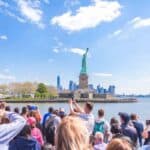 Tourists viewing Statue of Liberty from ferry