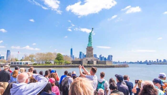 Tourists viewing Statue of Liberty from ferry