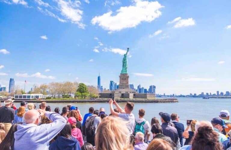 Tourists viewing Statue of Liberty from ferry