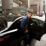 Man exiting black car on city street
