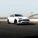 White Lamborghini Urus on bridge roadway