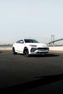 White Lamborghini Urus on bridge roadway