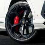 Close-up of sports car wheel with red brake caliper