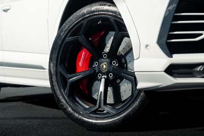 Close-up of sports car wheel with red brake caliper