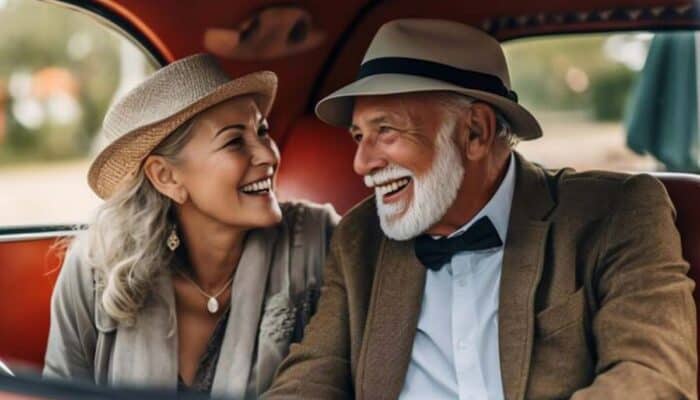 Smiling elderly couple in vintage car