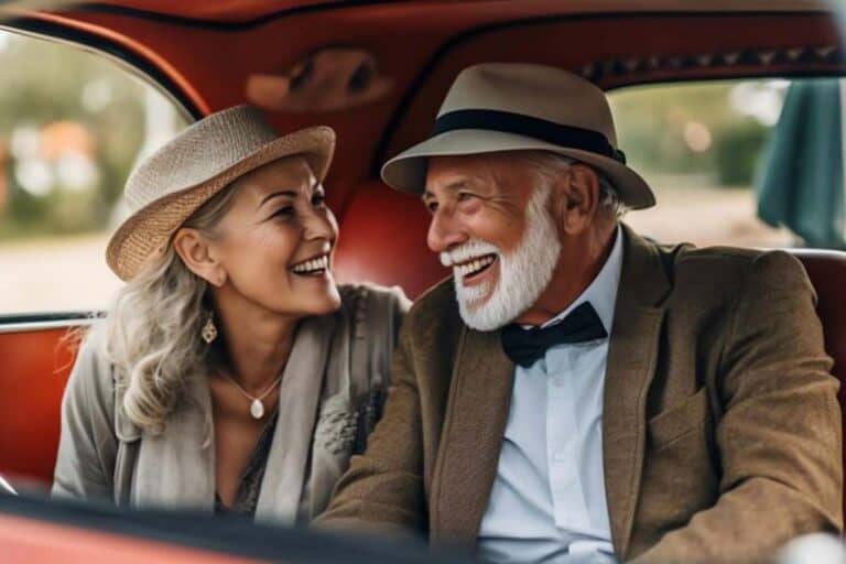 Smiling elderly couple in vintage car