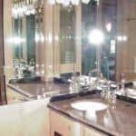 Bathroom vanity with granite countertop and large mirror